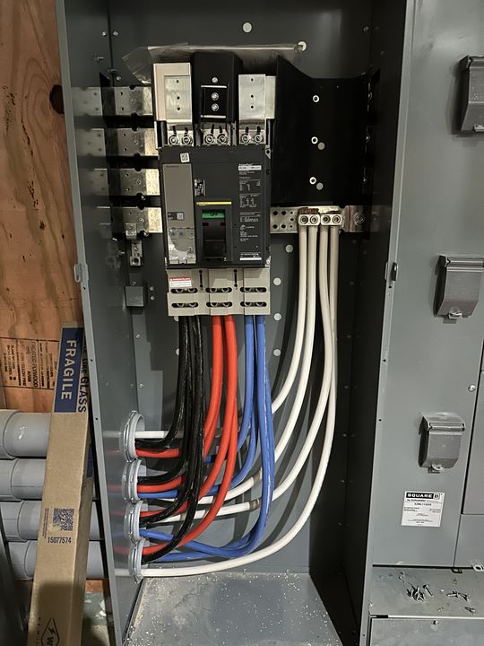 Large feeder conductors terminated in a commercial panel
