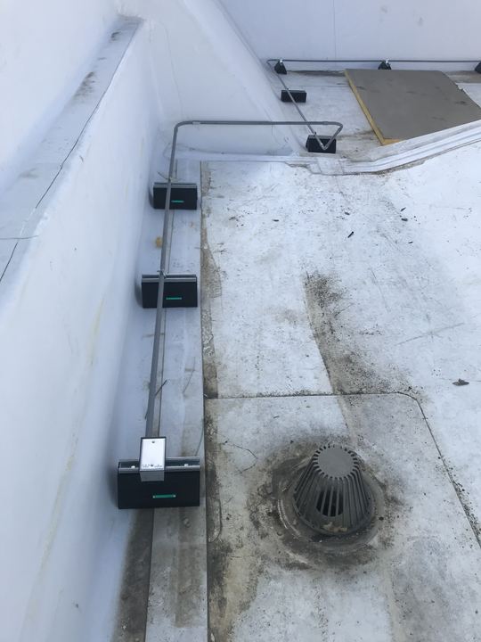Electrical conduits routed across a commercial roof