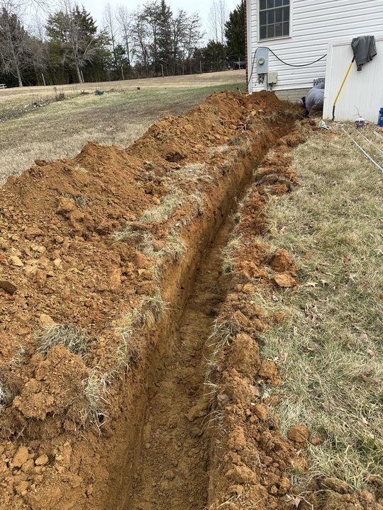 Excavated pathway for underground electrical conduit
