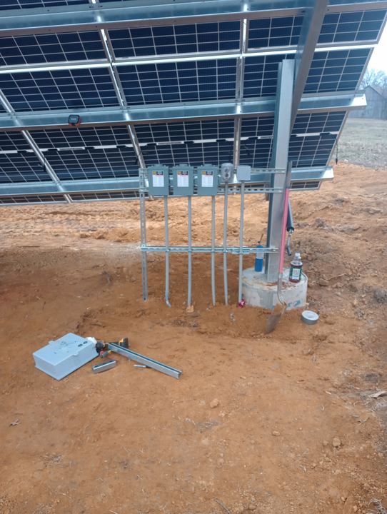 Electrical distribution equipment mounted beneath a solar array