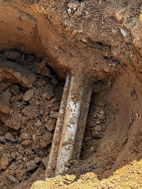 Underground electrical pathway exposed around an obstruction